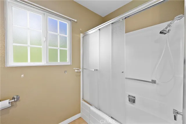 a front view of a house with a garden and trees