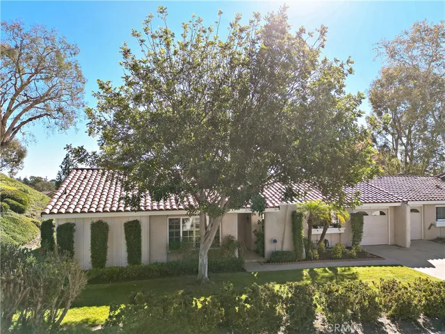 an aerial view of a house with a yard and lake view