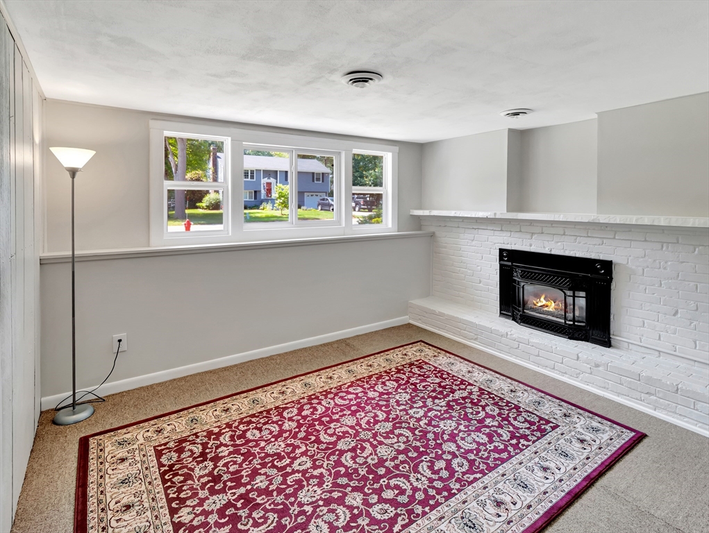 4 Gary Road Norton, MA 02766 - Photo 30 of 42 a living room with a fireplace and a rug