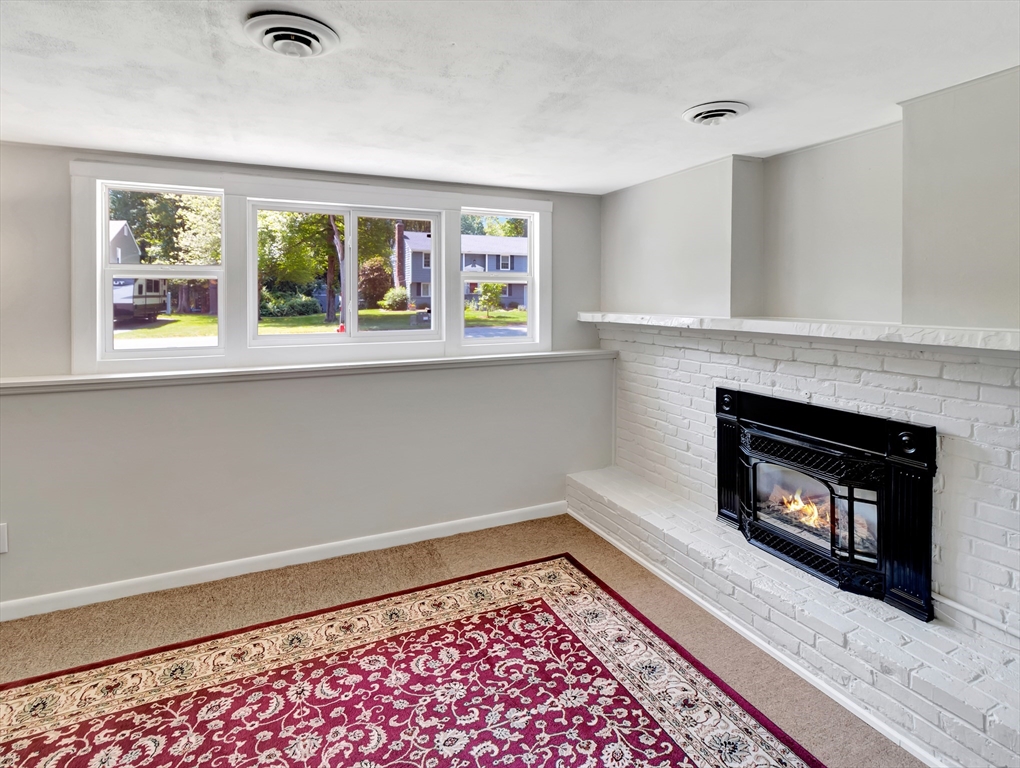 4 Gary Road Norton, MA 02766 - Photo 31 of 42 a view of a livingroom with a fireplace and window