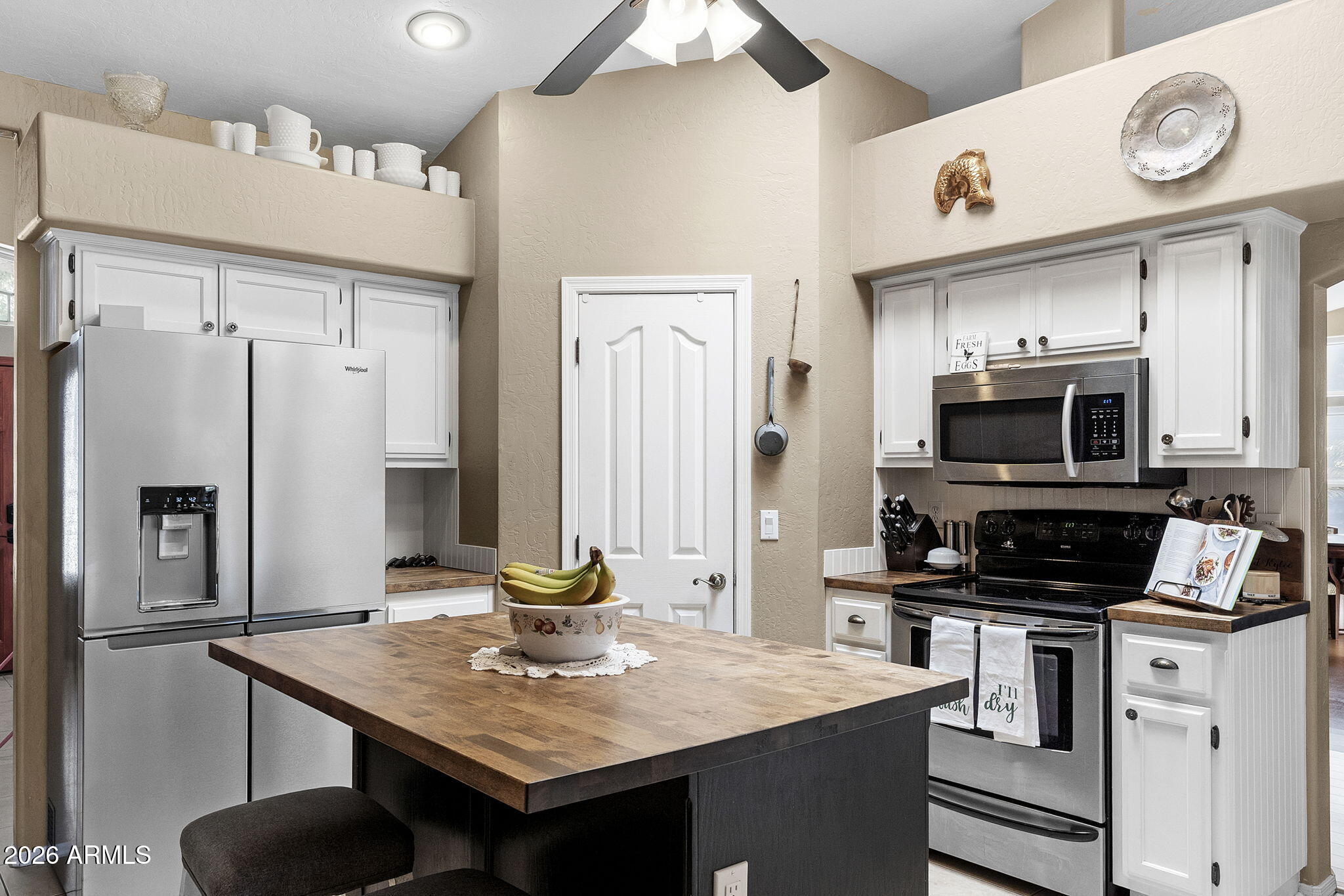 844 North Oracle Circle Mesa, AZ 85203 - Photo 14 of 34 a kitchen with stainless steel appliances kitchen island granite countertop a refrigerator a stove and a sink