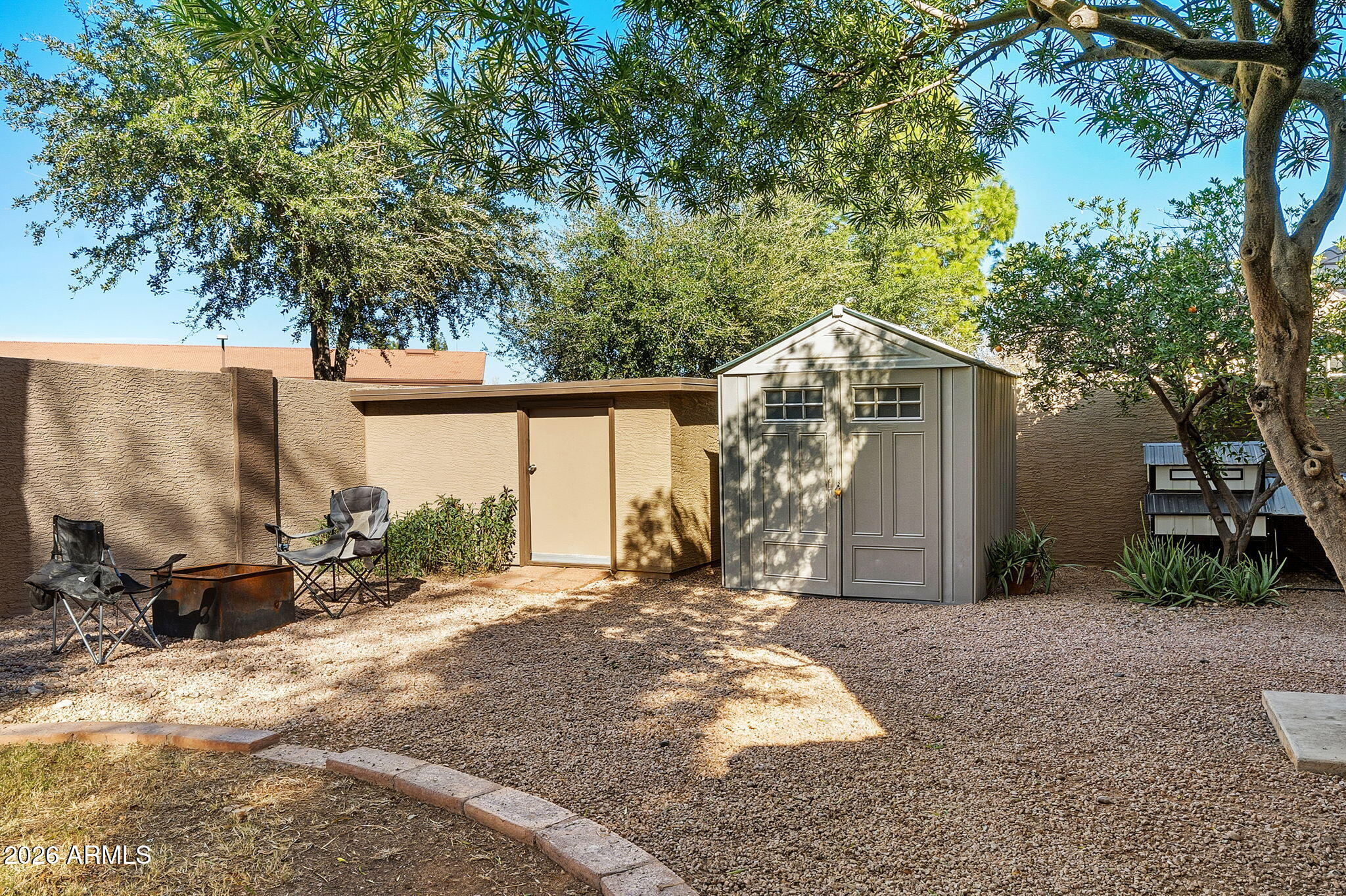 844 North Oracle Circle Mesa, AZ 85203 - Photo 32 of 34 a backyard of a house with large trees and outdoor seating