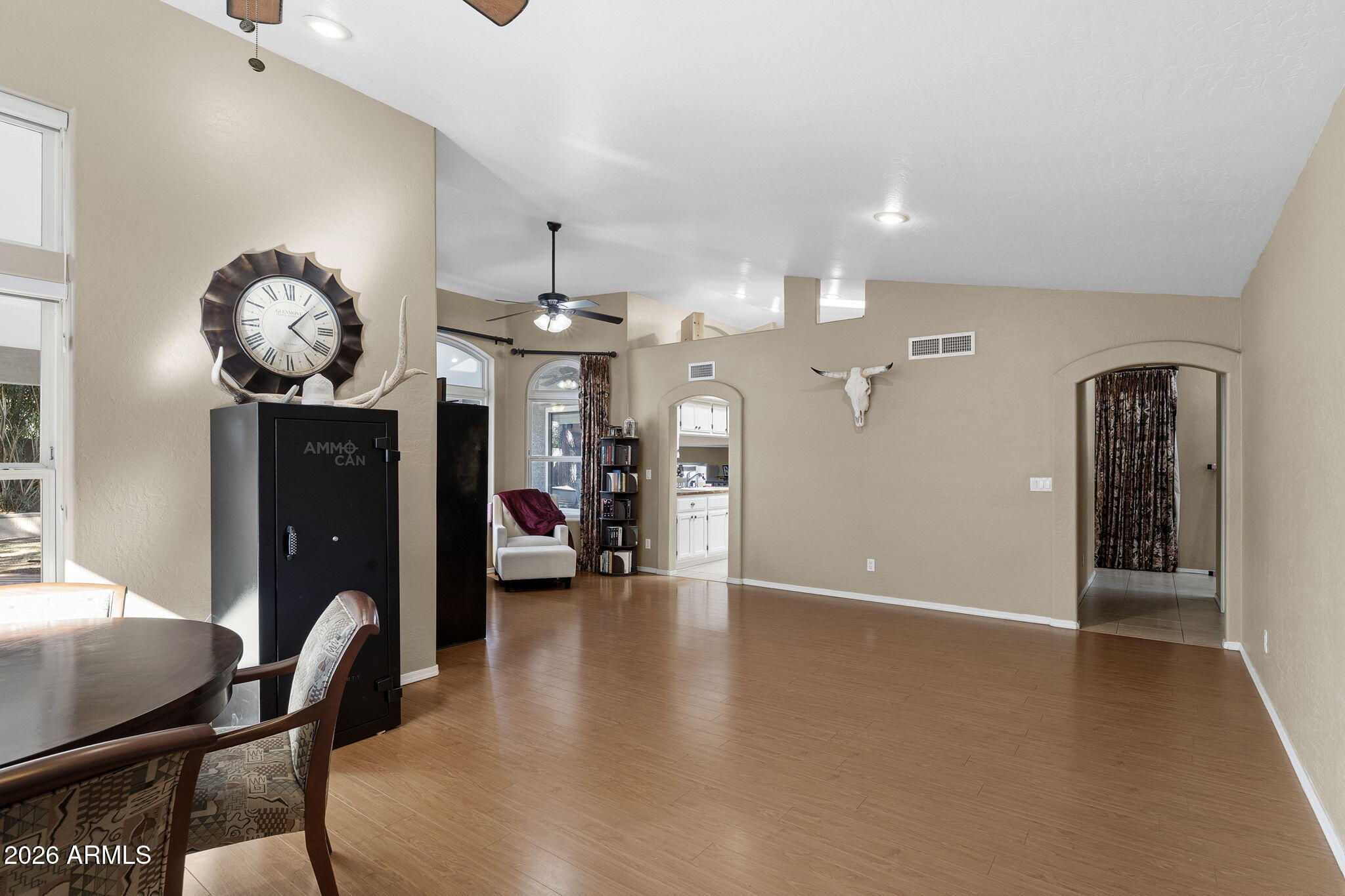844 North Oracle Circle Mesa, AZ 85203 - Photo 5 of 34 a view of a livingroom and a kitchen with furniture and a chandelier