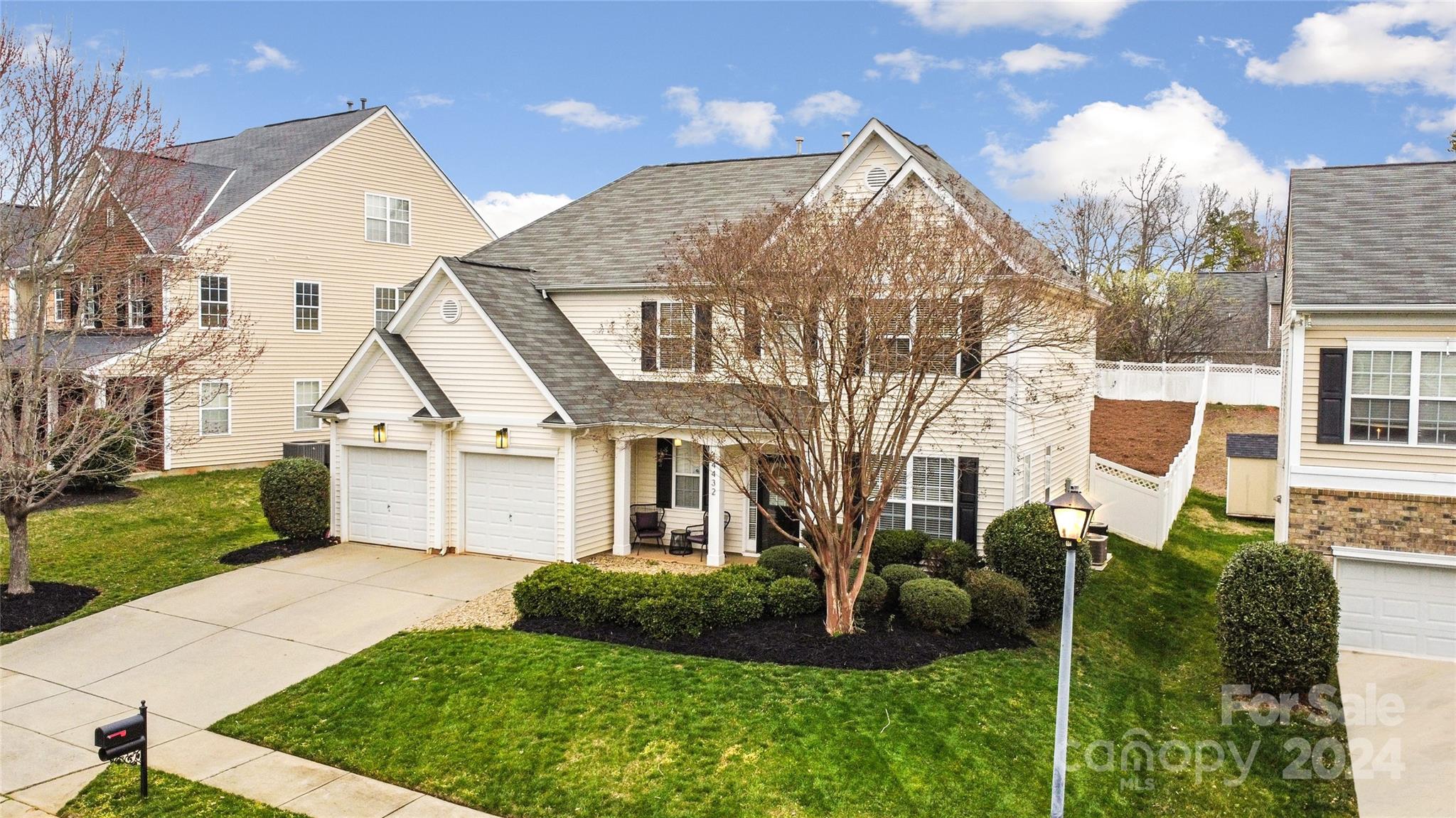 14432 Whistling Swan Road Charlotte, NC 28278 - Photo 2 of 28 a view of a white house next to a yard with big trees