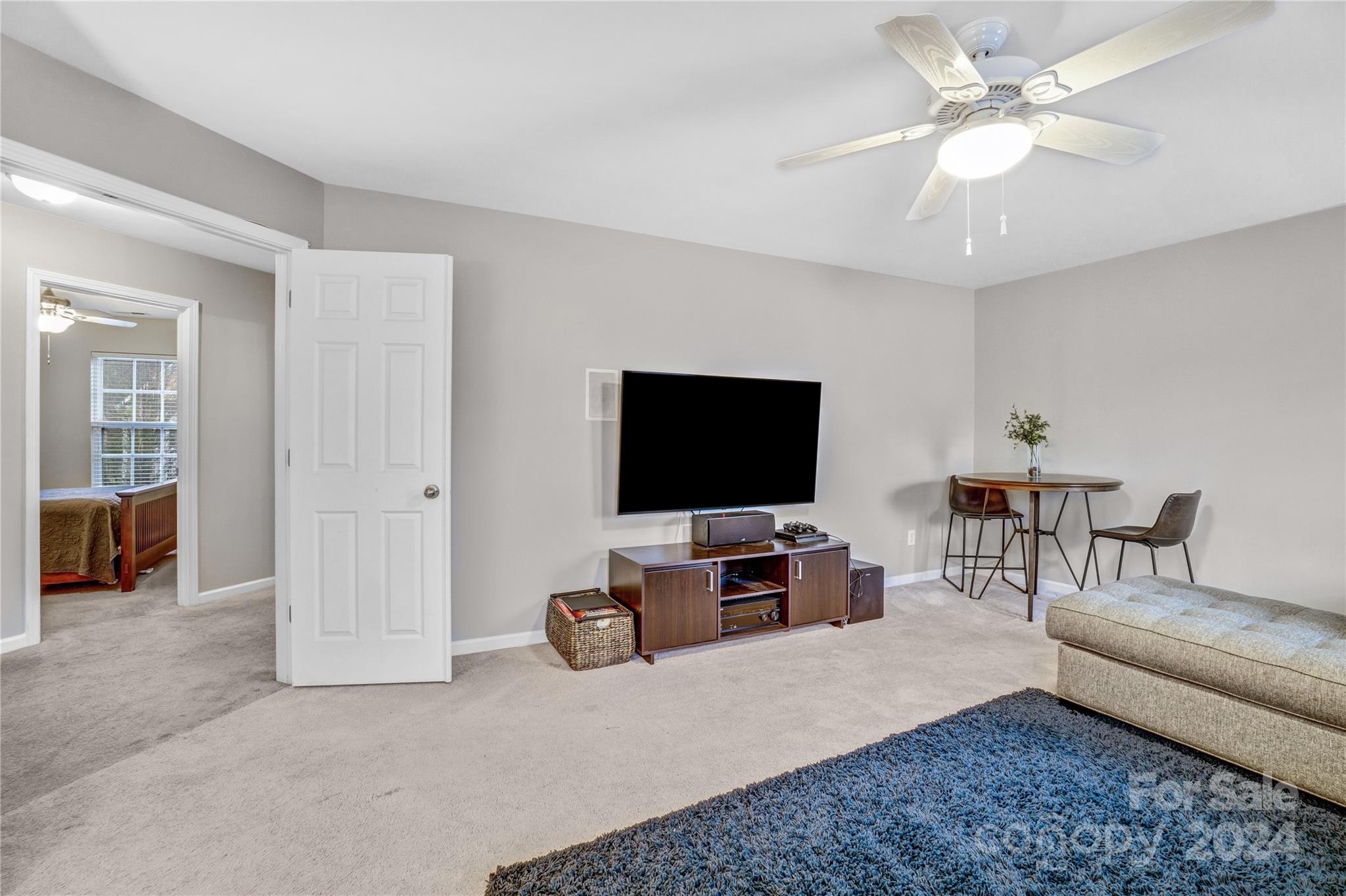 14432 Whistling Swan Road Charlotte, NC 28278 - Photo 22 of 28 a living room with furniture and a flat screen tv