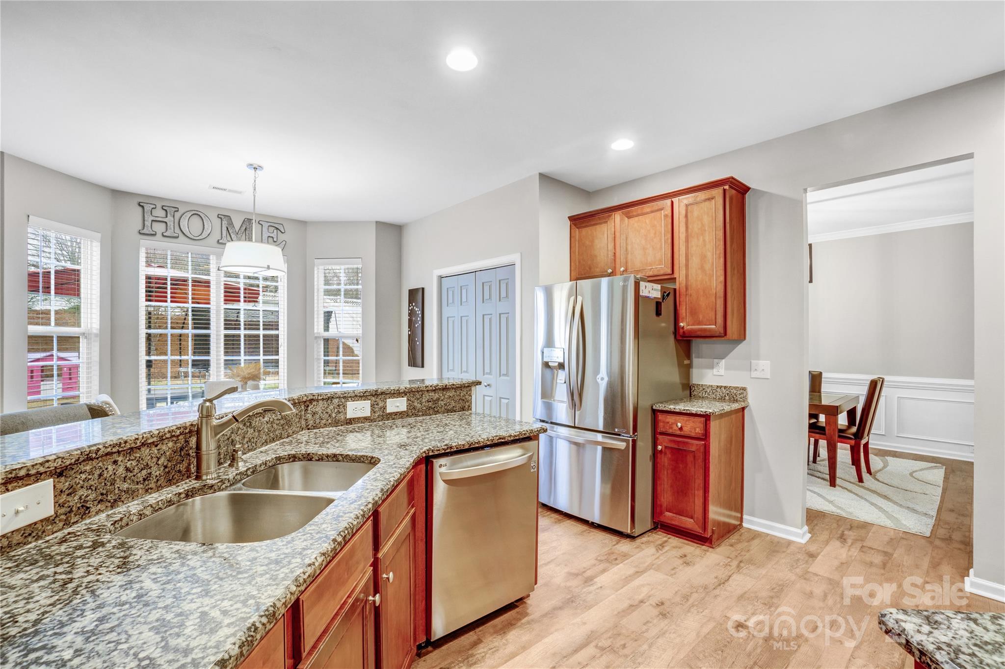 14432 Whistling Swan Road Charlotte, NC 28278 - Photo 8 of 28 a kitchen with stainless steel appliances granite countertop a sink stove and refrigerator