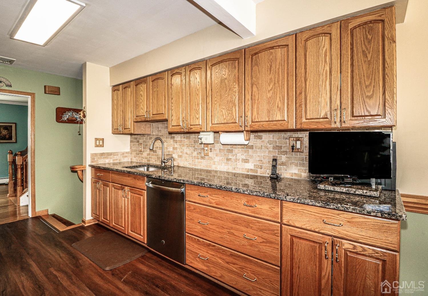 5 Pendleton Place Edison, NJ 08820 - Photo 11 of 37 a kitchen with stainless steel appliances granite countertop a stove a sink and a microwave