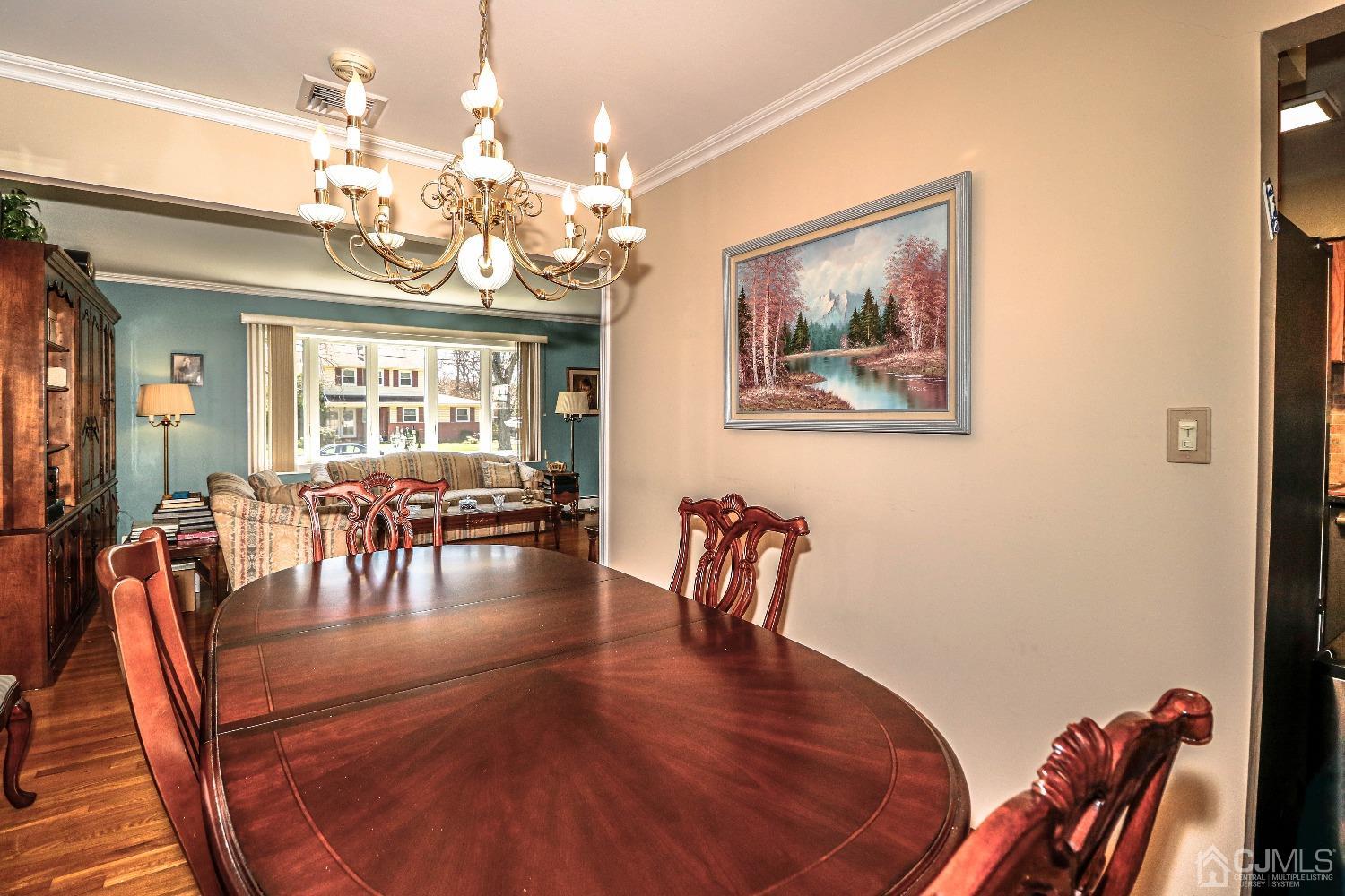 5 Pendleton Place Edison, NJ 08820 - Photo 17 of 37 a view of a dining room with furniture a chandelier and wooden floor