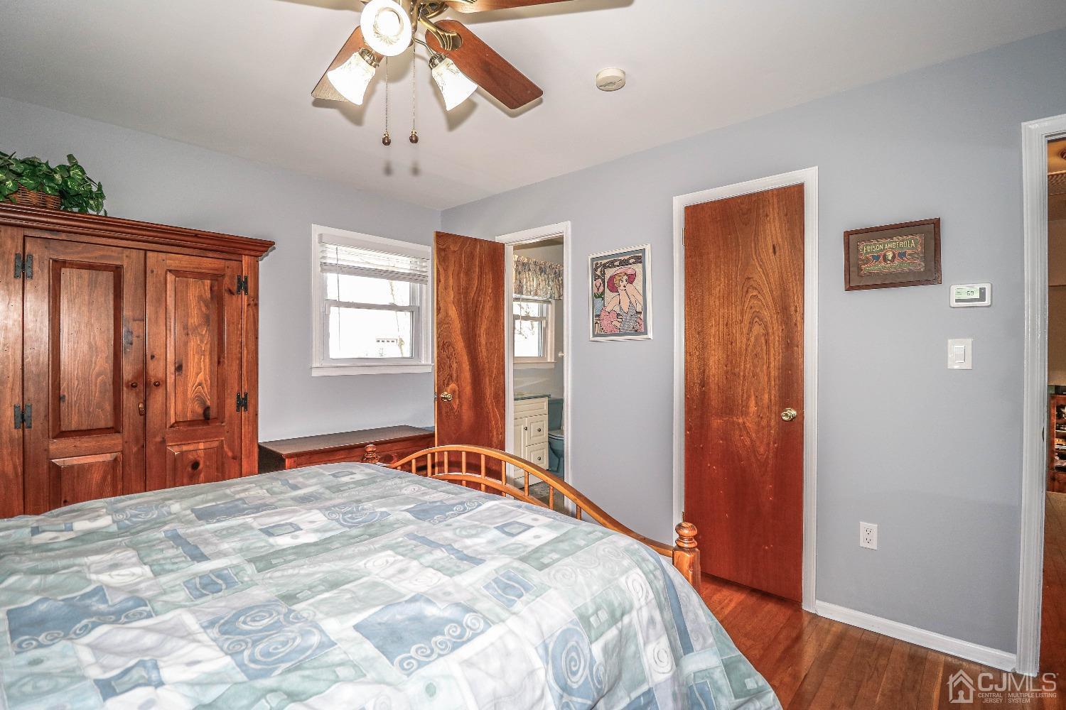 5 Pendleton Place Edison, NJ 08820 - Photo 24 of 37 a bedroom with a large bed and a chandelier