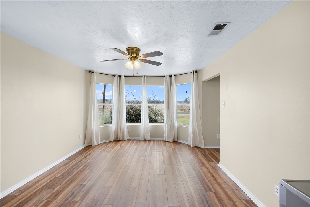 1172 County Road 268 Somerville, TX 77879 - Photo 18 of 40 an empty room with wooden floor and windows