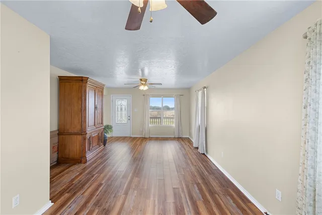 a kitchen with granite countertop white cabinets and stainless steel appliances