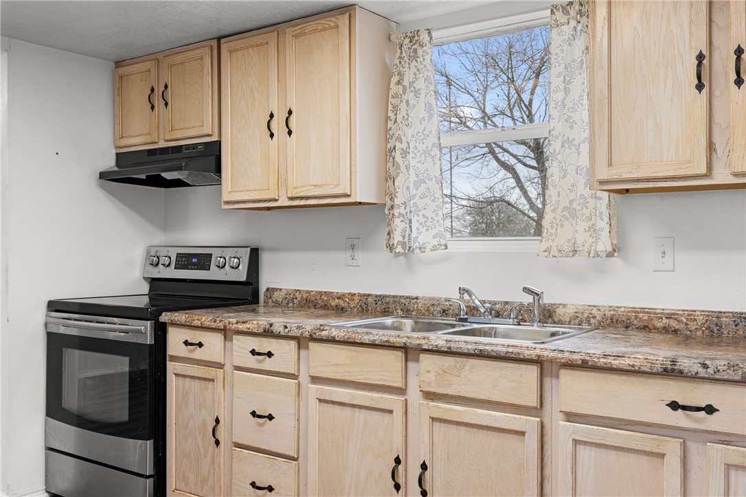 1172 County Road 268 Somerville, TX 77879 - Photo 23 of 40 a kitchen with granite countertop white cabinets and stainless steel appliances