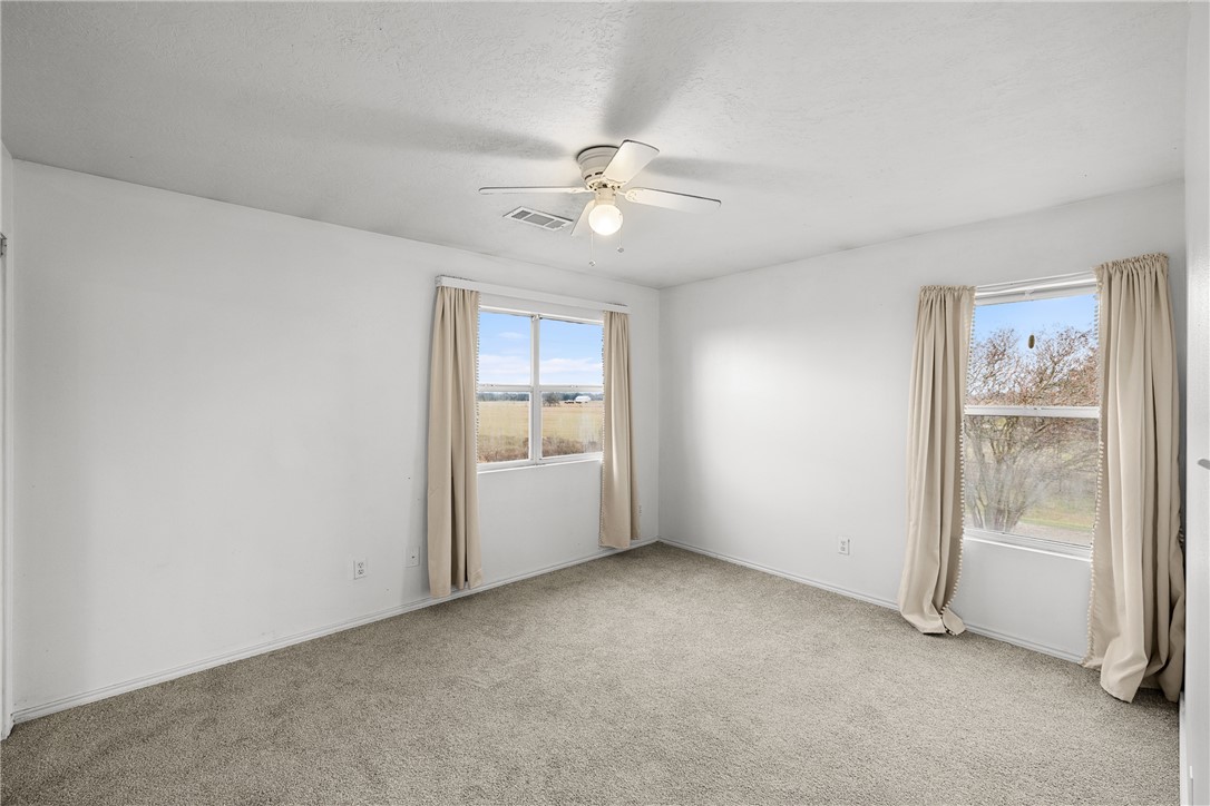1172 County Road 268 Somerville, TX 77879 - Photo 26 of 40 an empty room with chandelier fan and windows