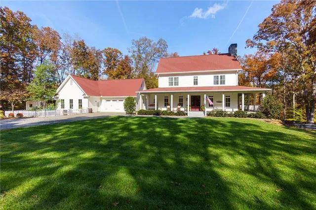 a view of house with yard and green space