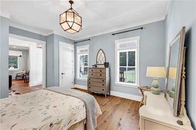 a kitchen with stainless steel appliances kitchen island granite countertop a table chairs refrigerator and microwave