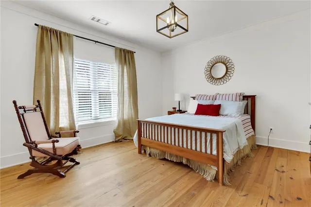 a living room with furniture a flat screen tv and a window