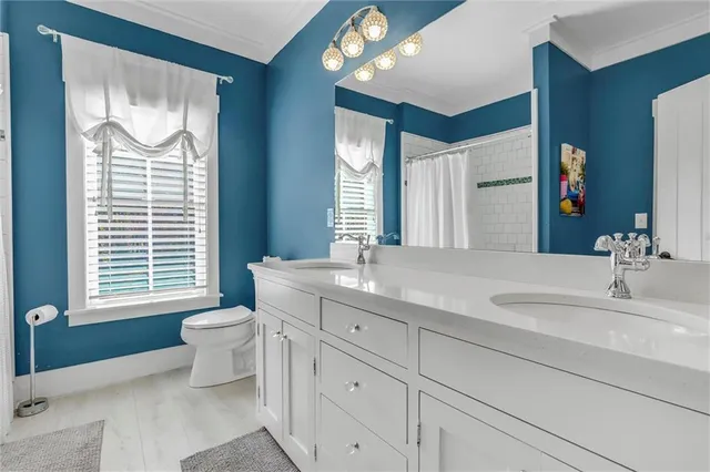 a kitchen with white cabinets and refrigerator