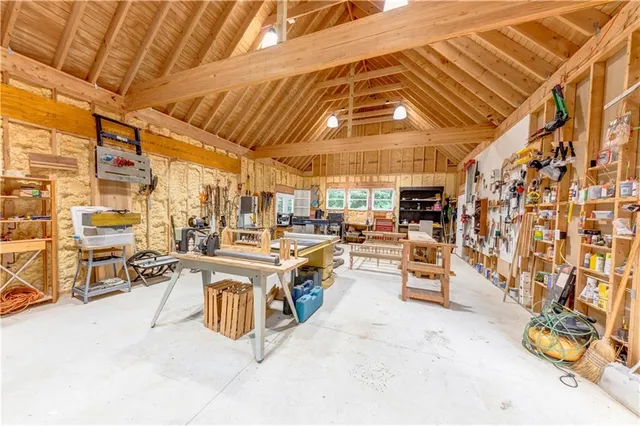 a dining area with a table chairs and a kitchen view