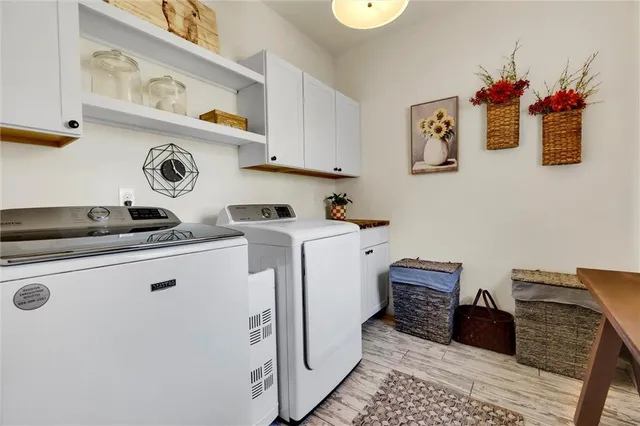 a bathroom with a sink a toilet a mirror and shower
