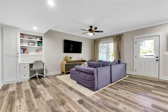 a living room with furniture and a wooden floor