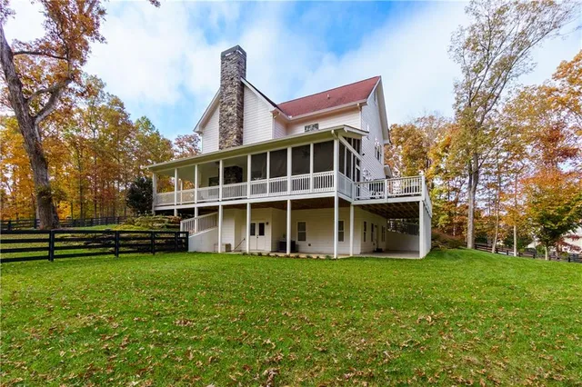 an aerial view of residential house with yard and mountain view
