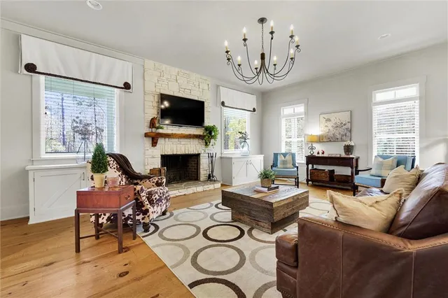 a living room with furniture or couch and a chandelier