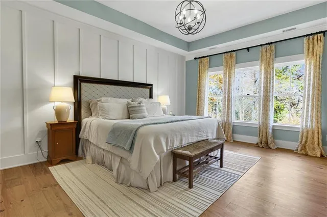 a kitchen with kitchen island granite countertop a sink cabinets and wooden floor