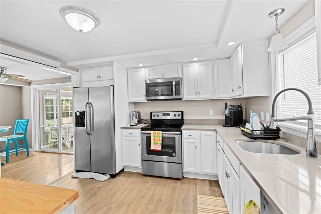 15 Packard Avenue Hull, MA 02045 - Photo 12 of 32 a kitchen with granite countertop a refrigerator stove and sink