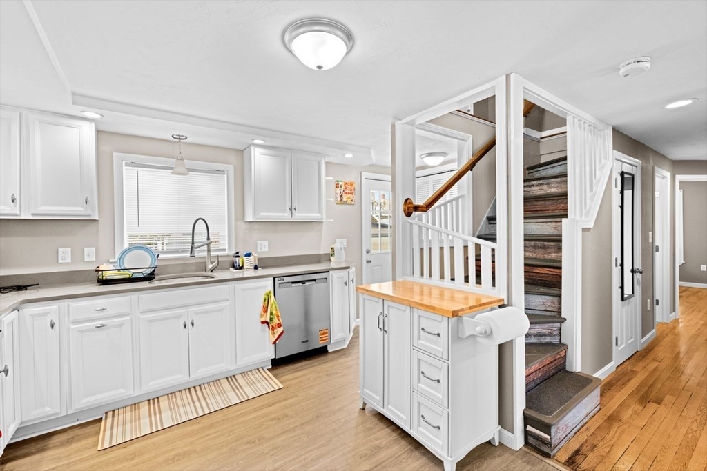 15 Packard Avenue Hull, MA 02045 - Photo 14 of 32 a hallway with cabinets a sink and a stove