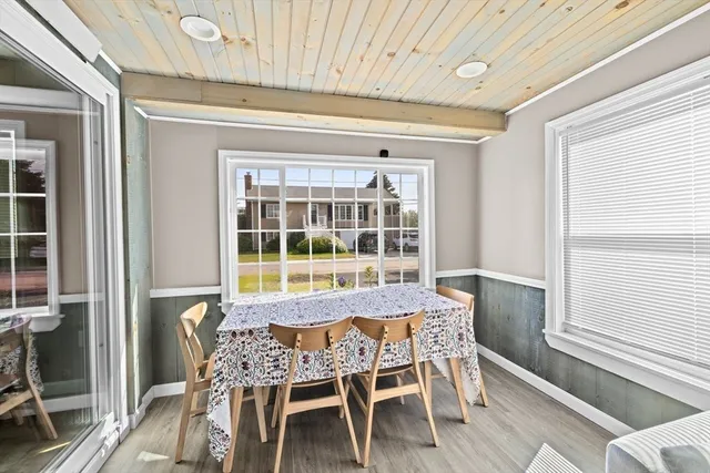 a view of a dining room with furniture and windows