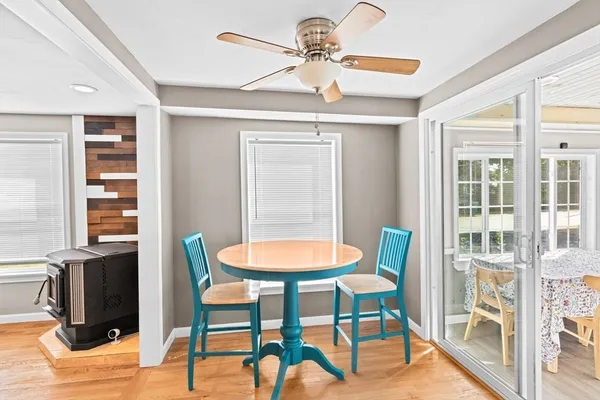 a dining room with furniture and a floor to ceiling window