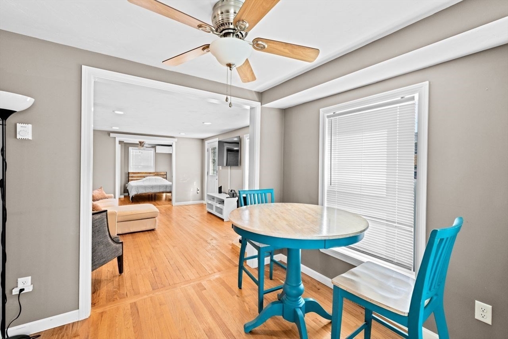 15 Packard Avenue Hull, MA 02045 - Photo 21 of 32 a living room with a table and chairs