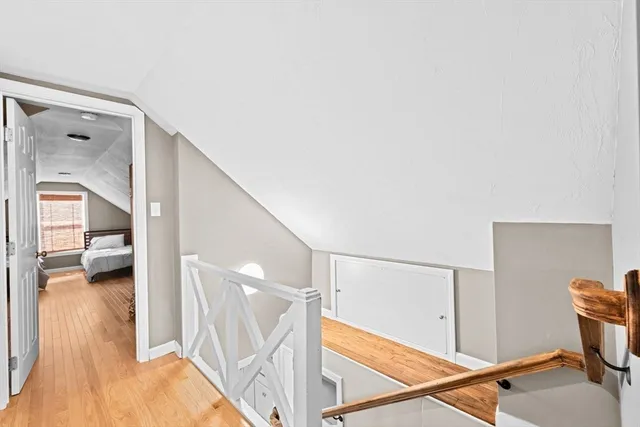 a view of a hallway and a livingroom with furniture