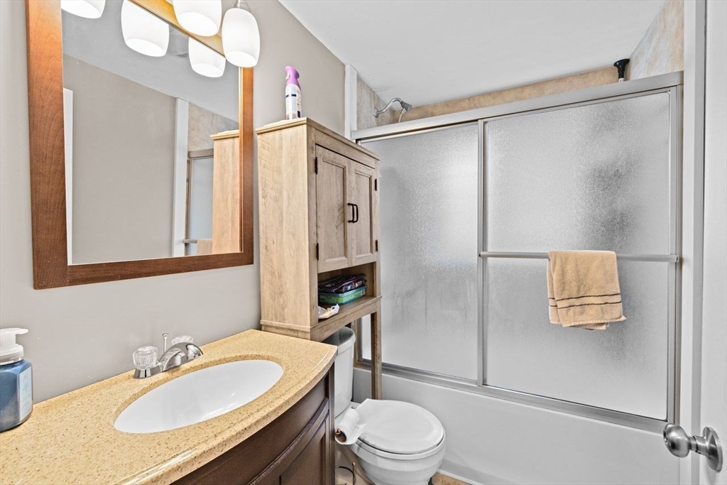 15 Packard Avenue Hull, MA 02045 - Photo 29 of 32 a bathroom with a sink toilet a mirror and shower