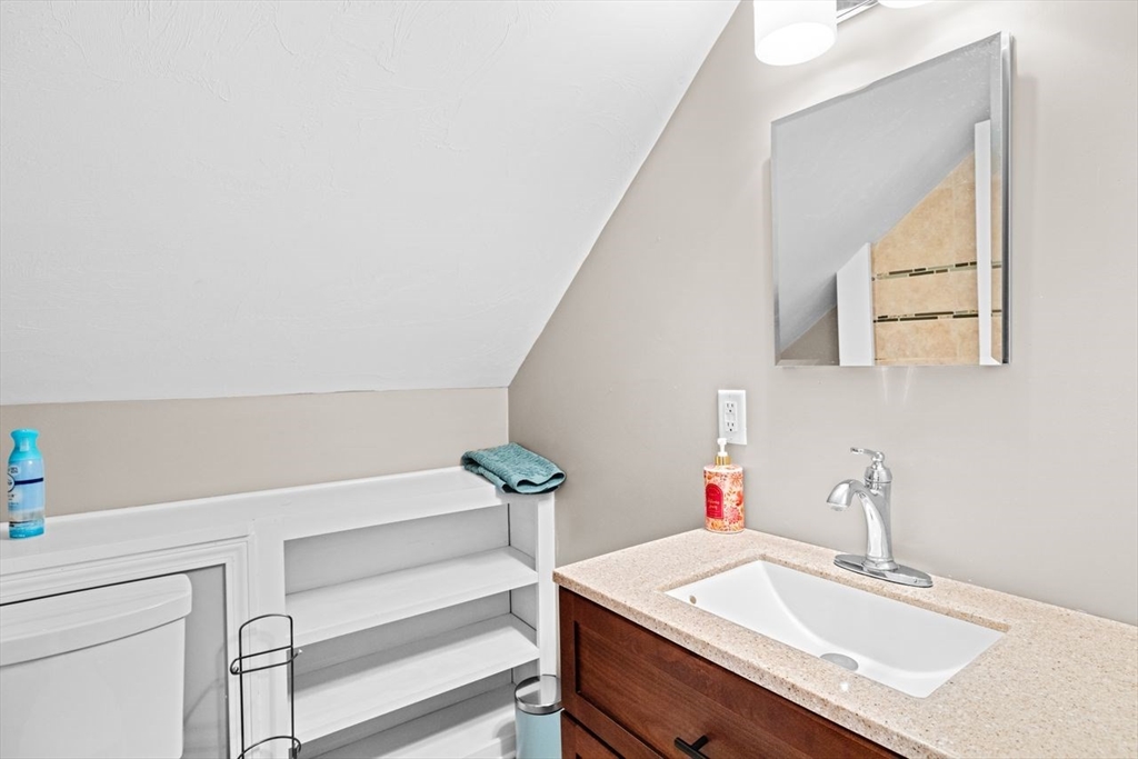 15 Packard Avenue Hull, MA 02045 - Photo 30 of 32 a bathroom with a sink and a mirror
