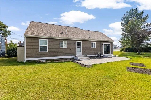 a view of a house with swimming pool and a yard
