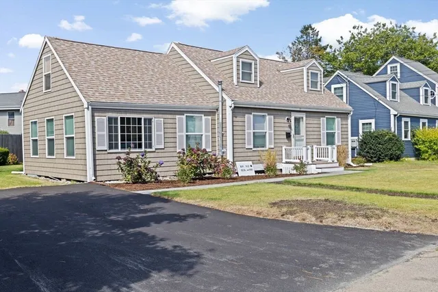 a front view of a house with a yard and porch