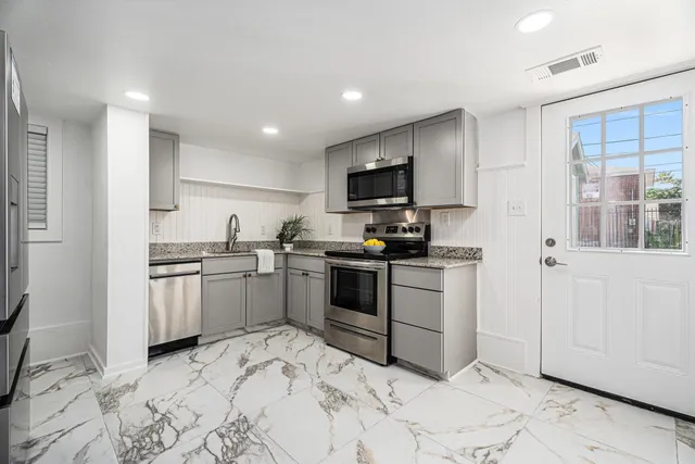 a kitchen with a sink stove and refrigerator
