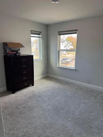 an empty room with windows and closet