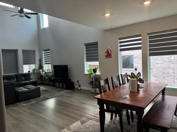 a view of a dining room with furniture window and wooden floor