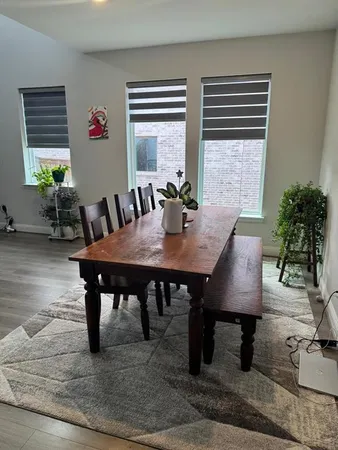 a view of a dining room with furniture window and wooden floor