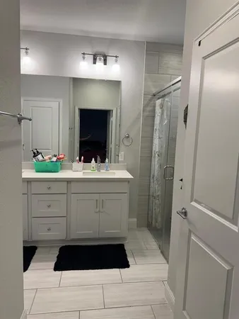 a bathroom with a sink a double vanity and a mirror