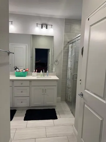a bathroom with a sink a double vanity and a mirror