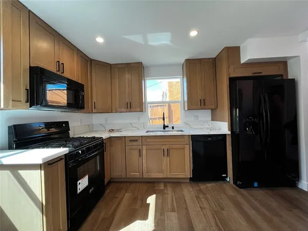 a kitchen with a sink stove and microwave