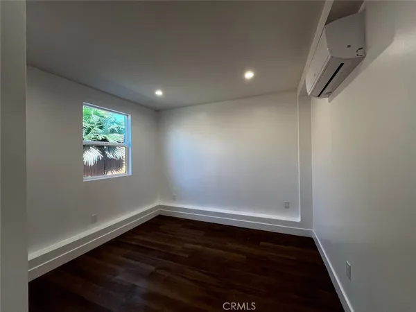 a view of room with window and hardwood floor