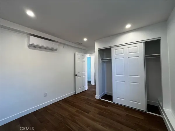 an empty room with wooden floor