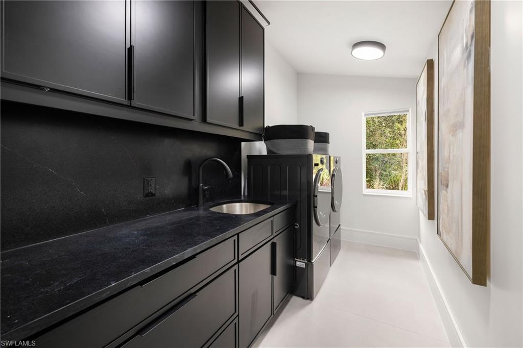 4521 3rd Avenue Northwest Naples, FL 34119 - Photo 23 of 46 a utility room with cabinets washer and dryer