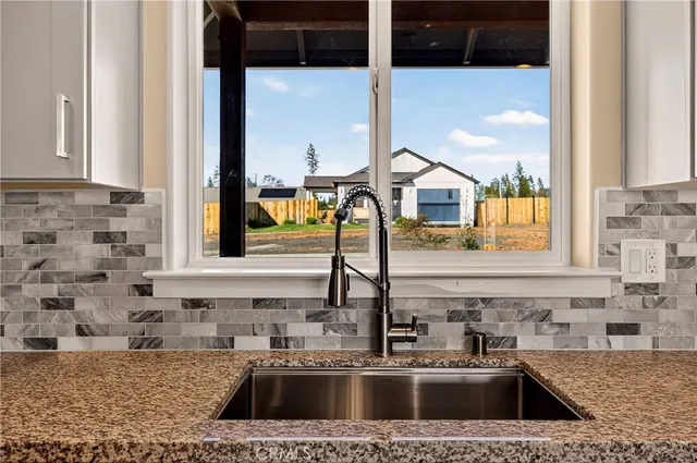 a kitchen with a sink a counter top space and cabinets