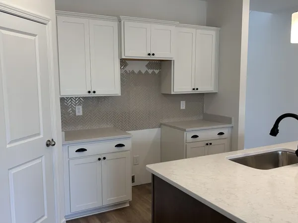 a view of cabinets and wooden floor
