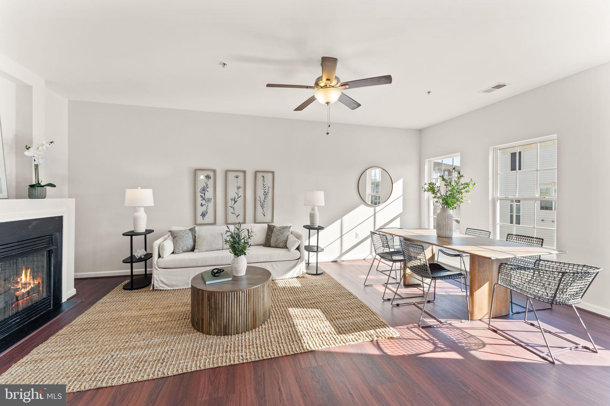 6072 Wicker Lane, Unit 160 Centreville, VA 20121 - Photo 18 of 58 a living room with furniture a fireplace and a chandelier